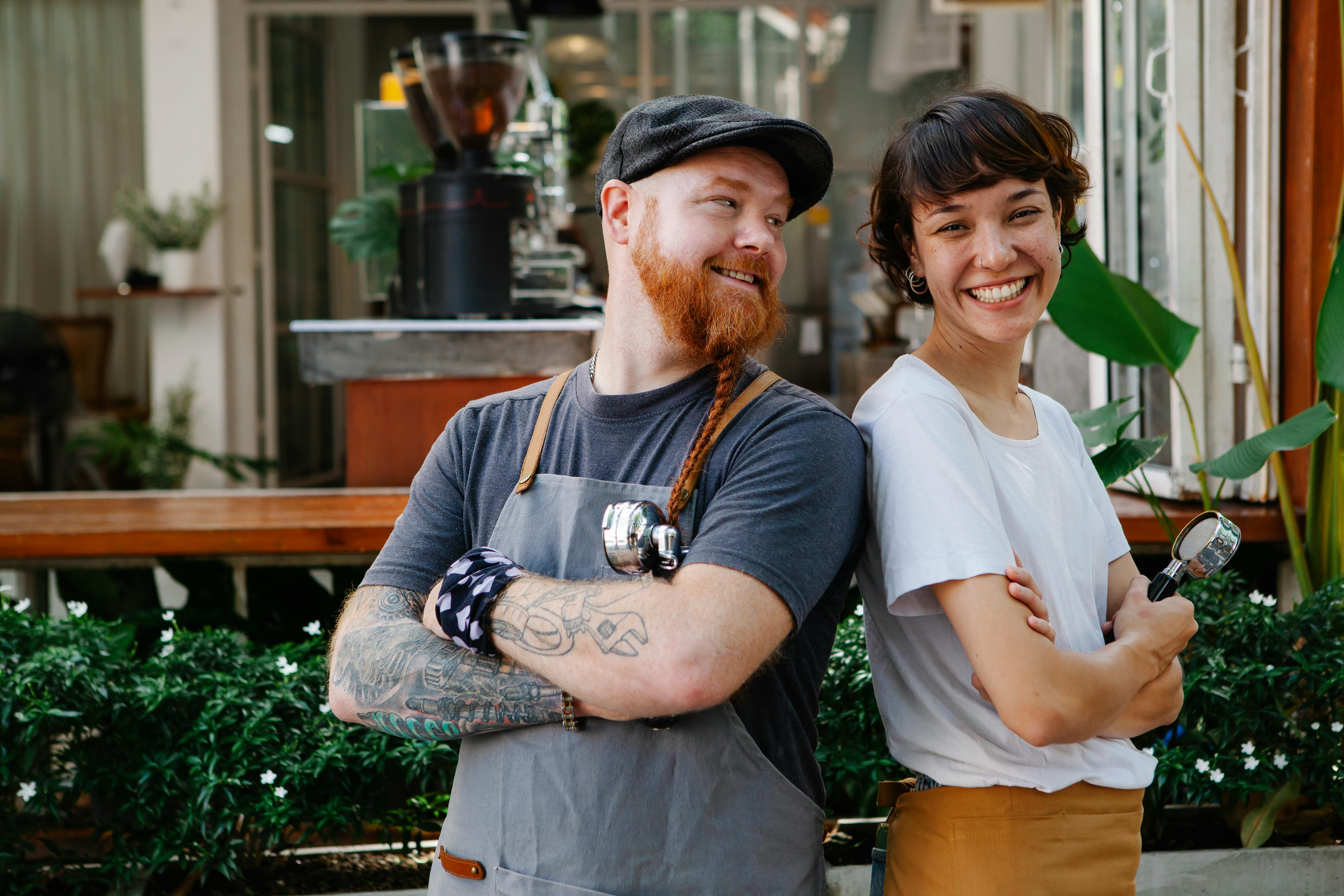 Man and Woman Business Owners Back to Back Smiling