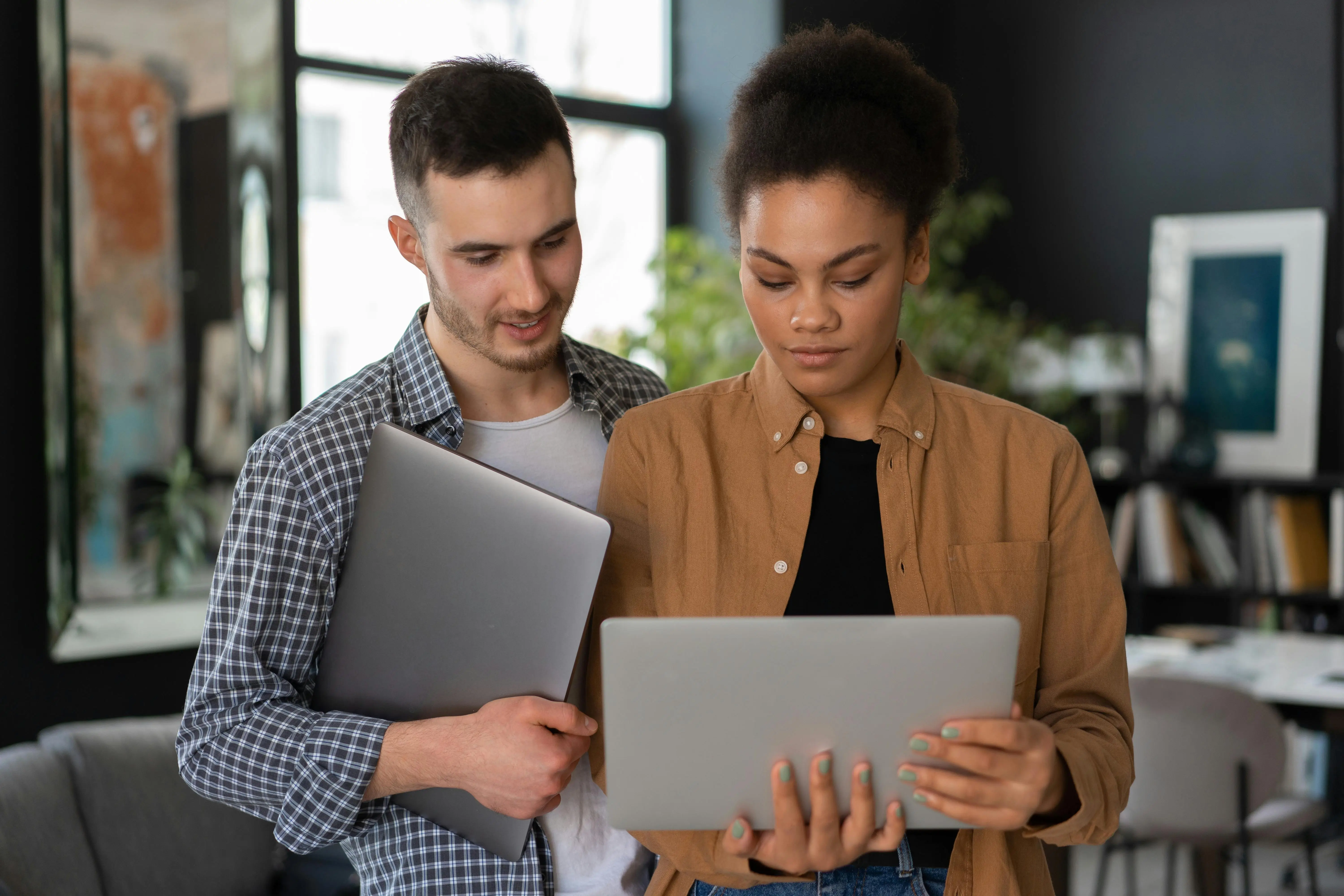 Man and a Woman Looking at Open Laptop